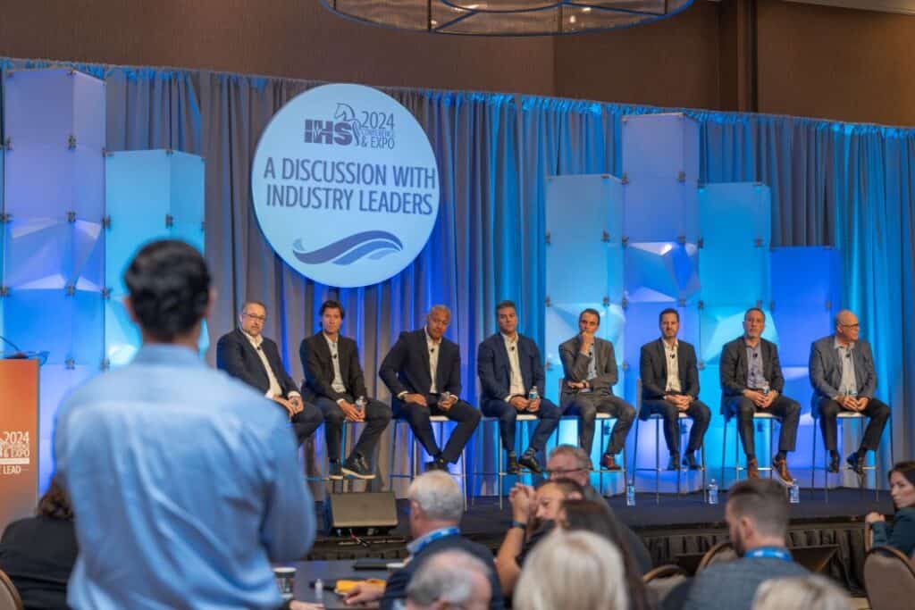 IHS Conference attendee is standing in front of a panel of indutry leaders to ask a question