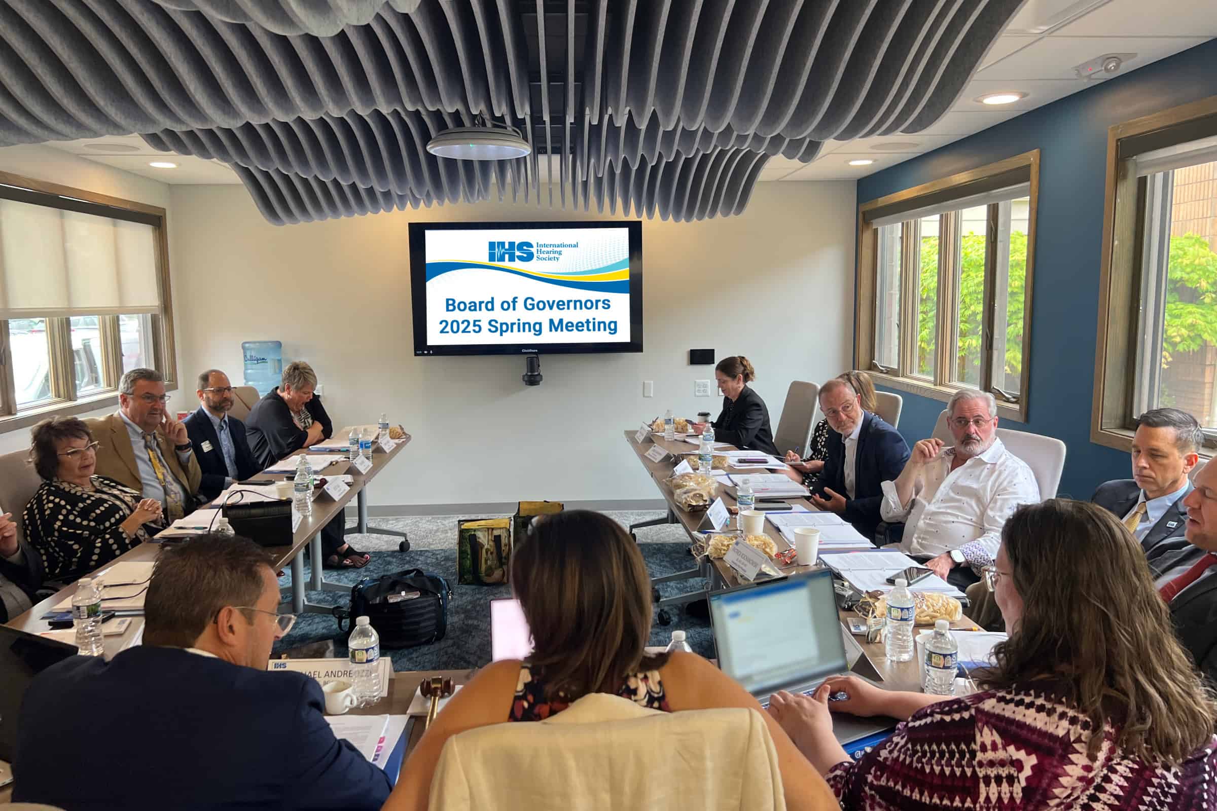 board of governors and IHS staff sit in a conference room for the spring meeting