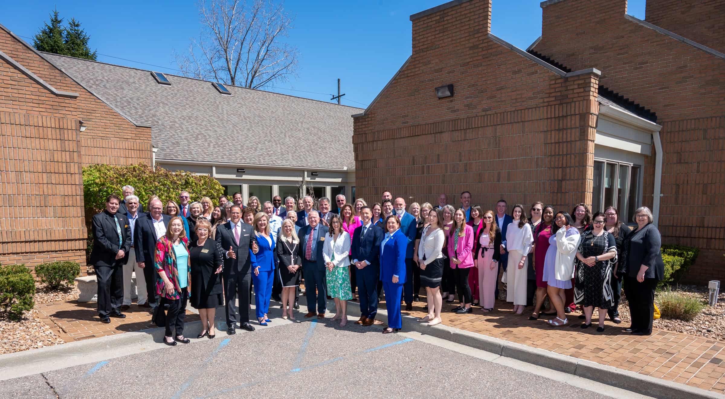 members, board of governors, staff, and industry leaders posed in front of the IHS World Headquarters following the official opening and ribbon cutting event.