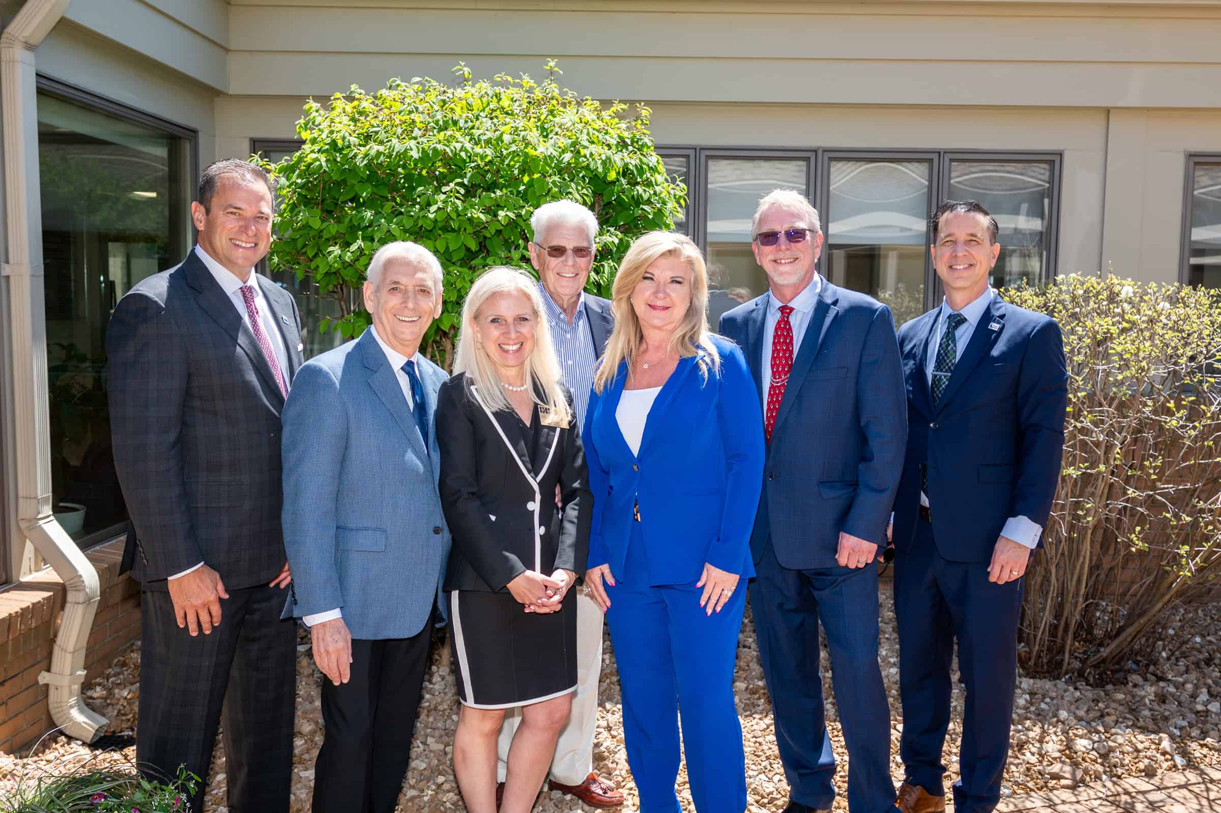 Eight IHS Members pose together outdoors for a group photo.
