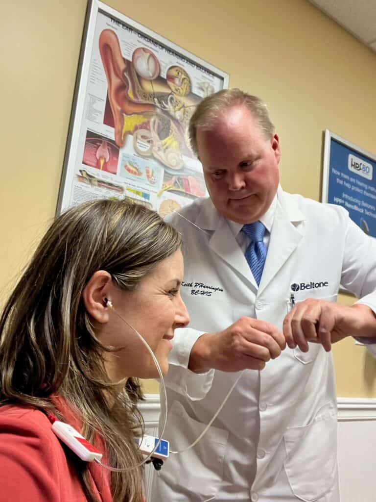 Executive Director Alissa Parady at a hearing health check with an IHS member.