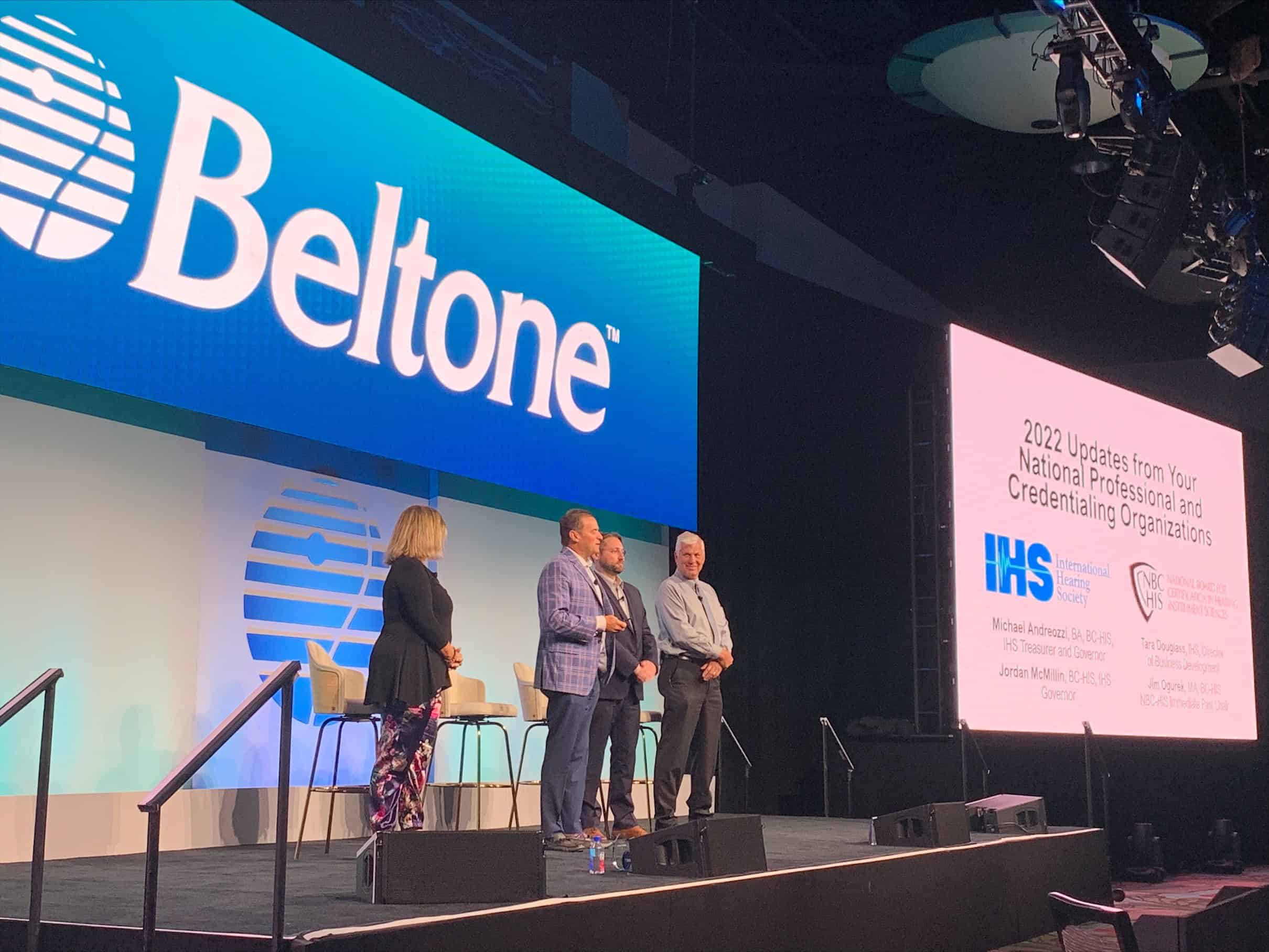 IHS leaders stand on stage during a Beltone National Meeting