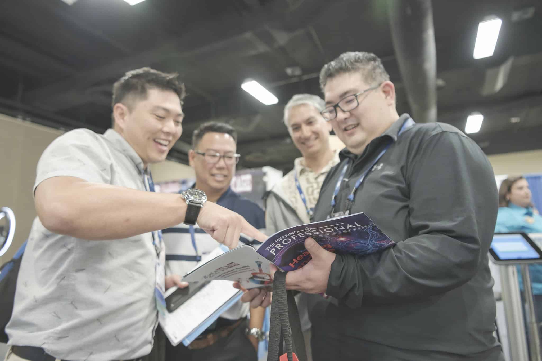 groups of men pointing to a page in a magazine