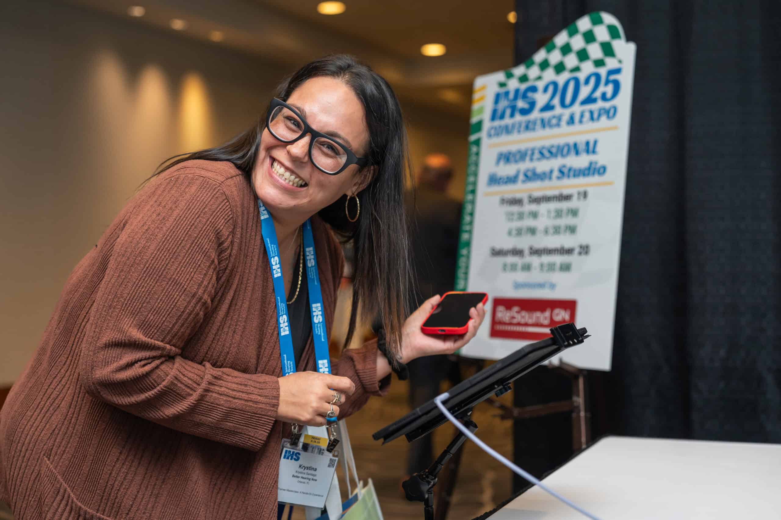 attendee reviewing the pictures that were taken during the headshot station at the IHS Conference & Expo