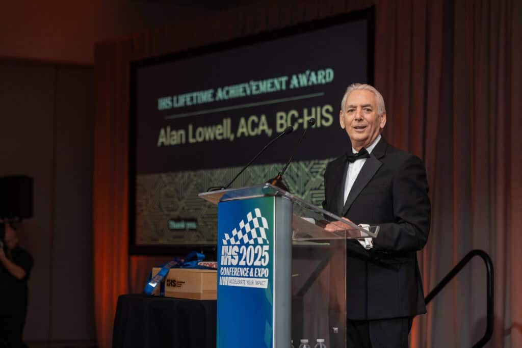 2025 Lifetime Achievement Award Winner, Alan Lowell, ACA, BC-HIS, accepting the award on stage.