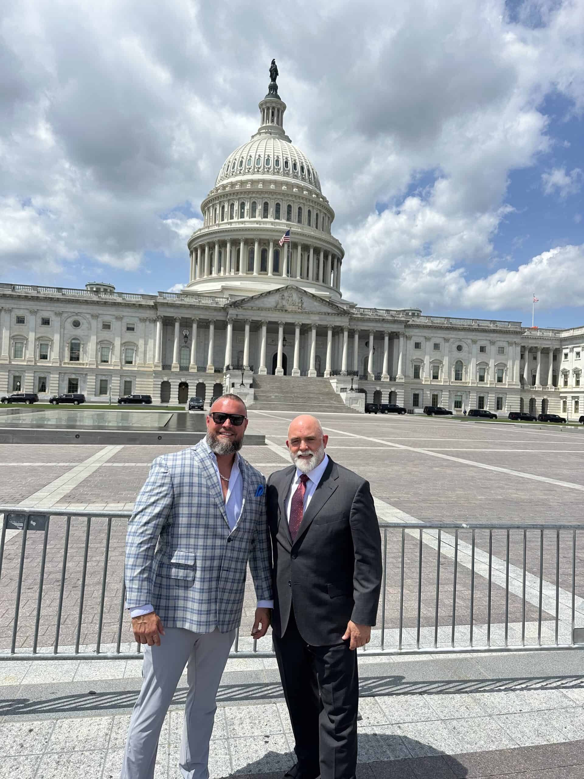 two IHS members pose in front of the US Capitol Building
