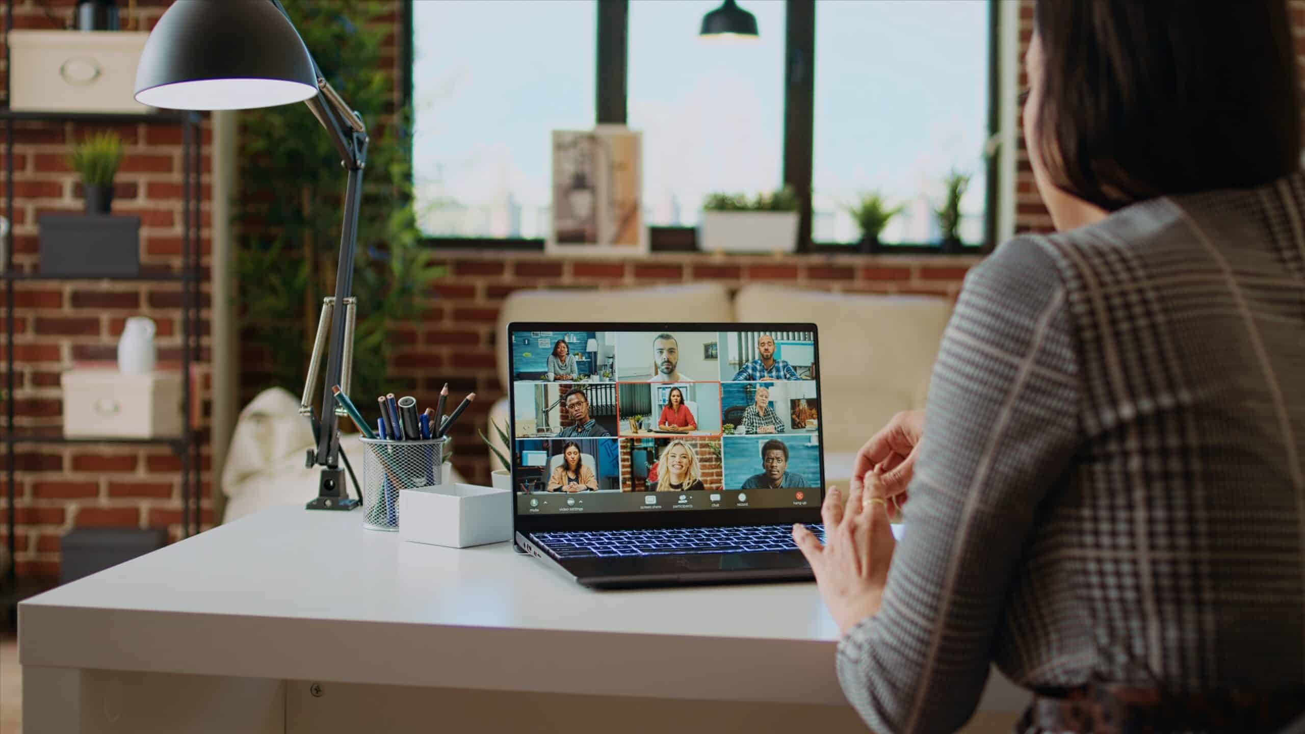 Woman participating in a virtual speaker training session on laptop.