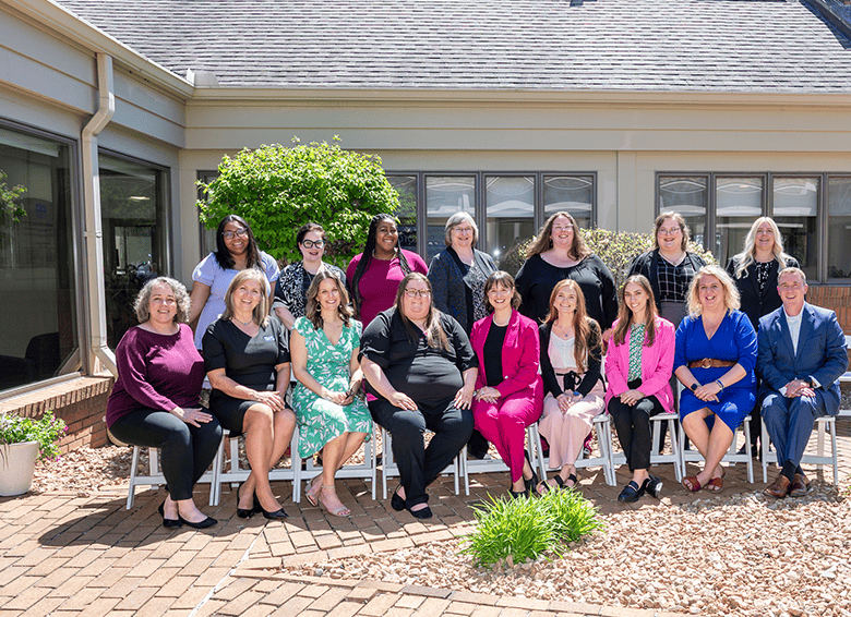 image of various IHS staff members posed in the IHS World Headquarters courtyard