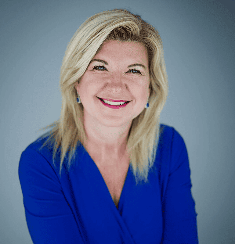 Annette Cross, BC-HIS, smiling in a blue top. Professional headshot.