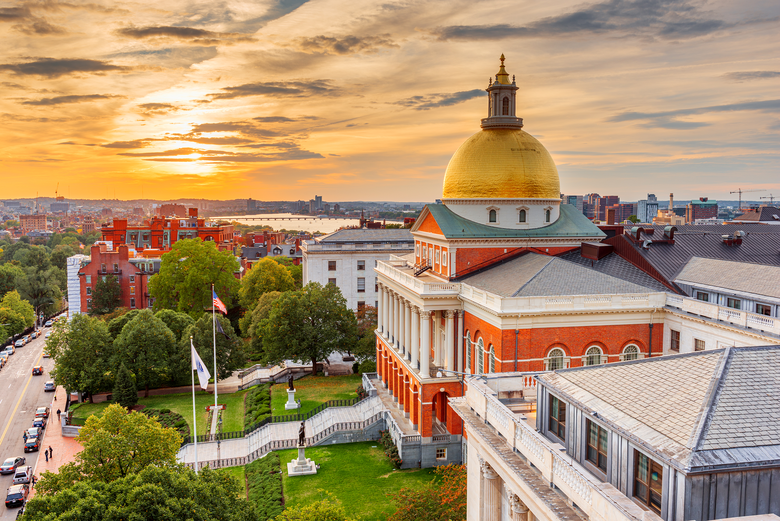 Golden-domed Massachusetts State House in Boston at sunset.