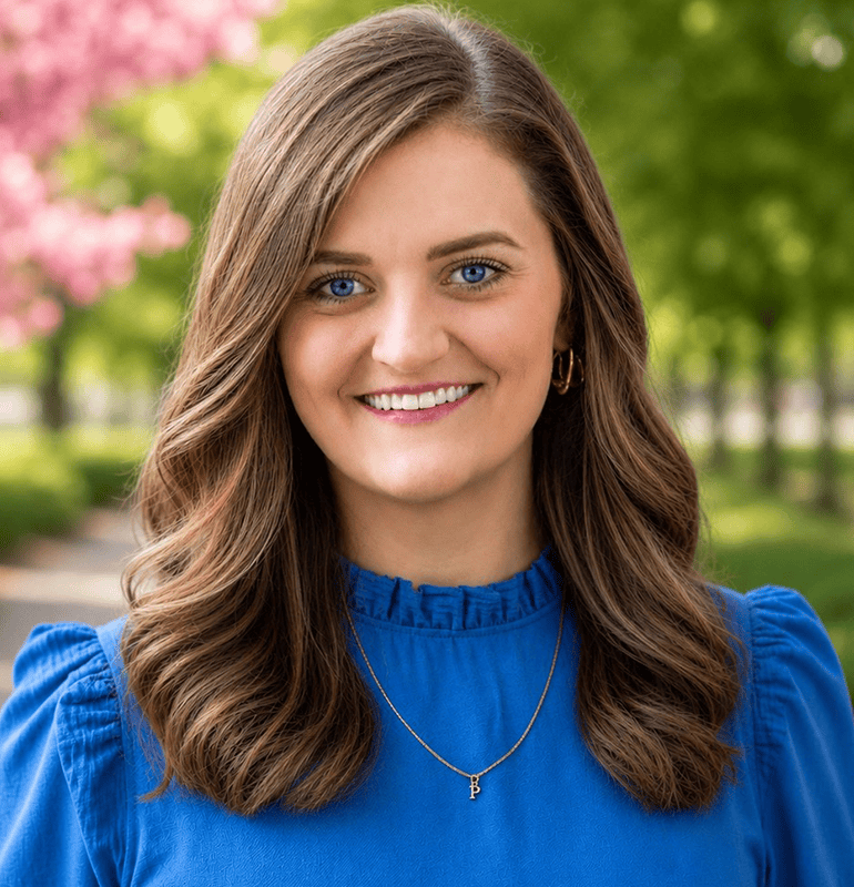 Young woman with long brown hair and blue eyes smiling