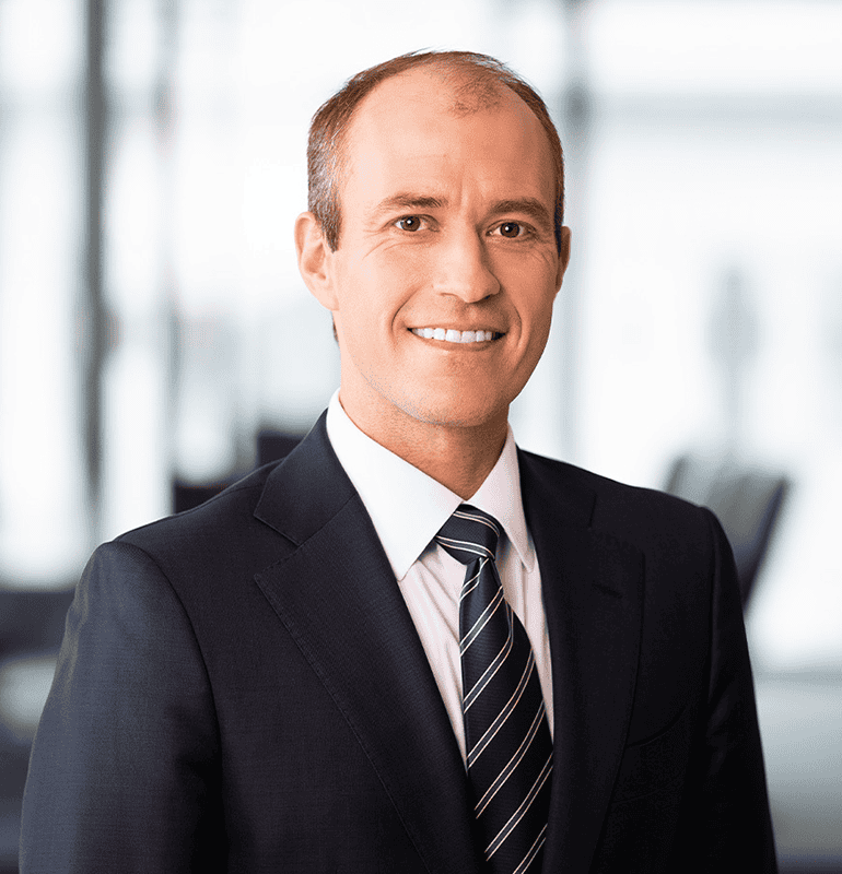 Zachary S. Pfister, a smiling man in a suit and tie, headshot