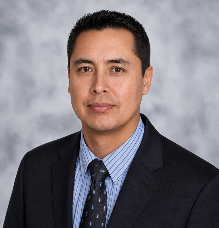 Professional portrait of a man in a suit and tie.